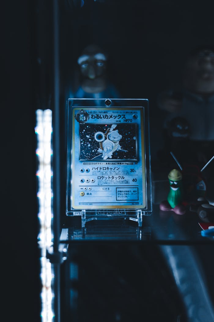 Rare Pokémon card displayed in a dimly lit shelf with character figurines.